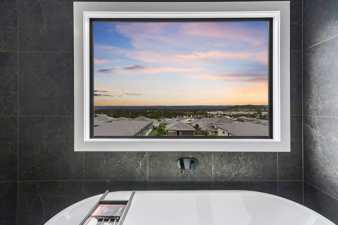 SHD18-DevineDrafting&Design-TheLayoftheLand-windowoverbath-sunset-housesview Image Credit: Classic Building & Design